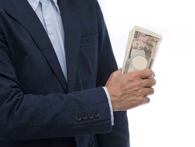 Hand holding Japanese banknote on white background. Japanese money.