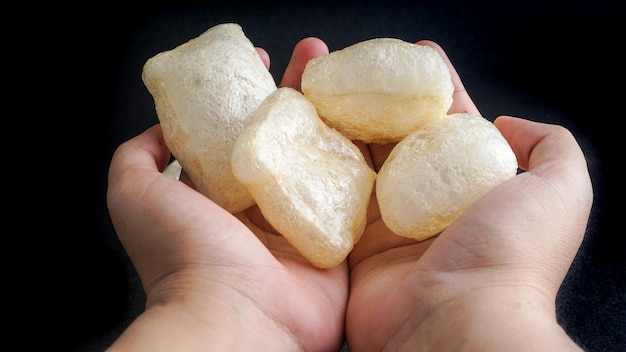 Hand holding Kerupuk Kulit Indonesian traditional crackers Selective Focus