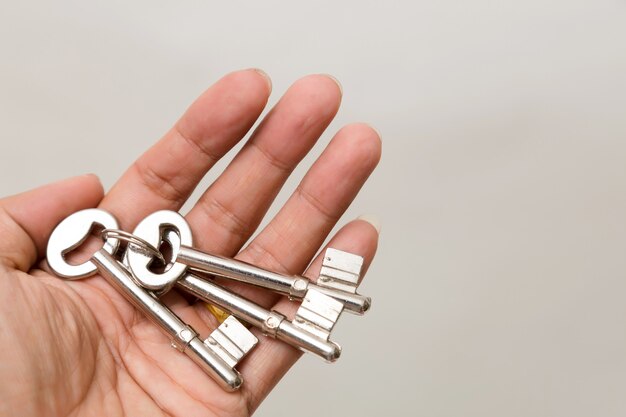 Hand holding the key Isolated. Studio lighting. 