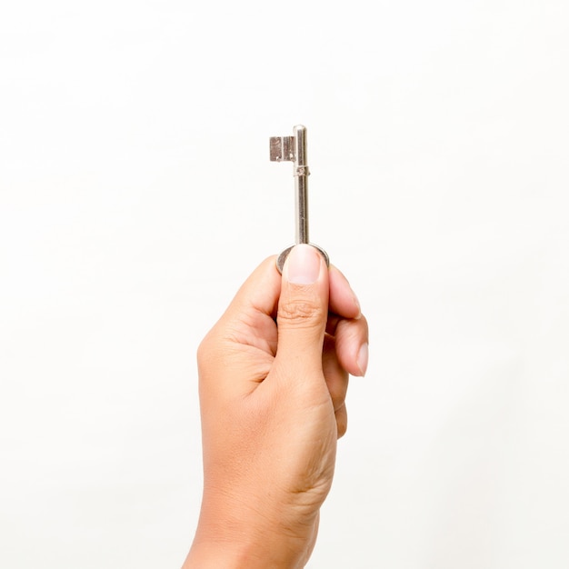 Hand holding the key Isolated on white