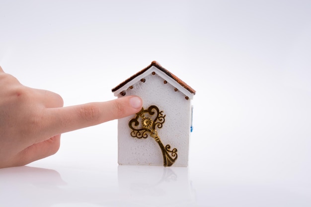 Hand holding a key near a house