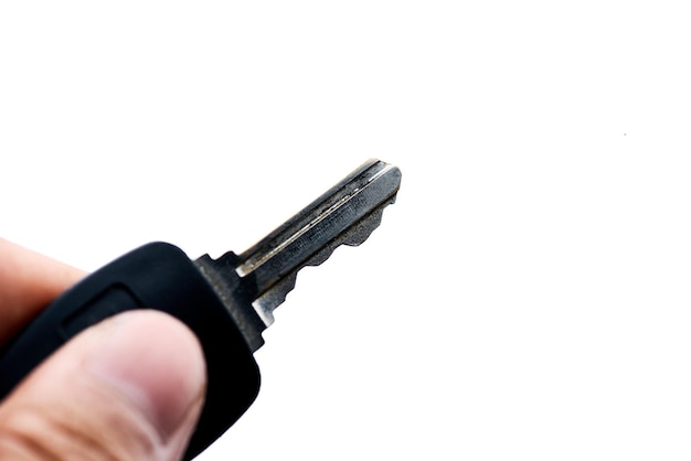 A hand holding a key that is plugged into a cord