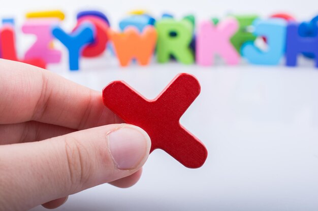 Photo hand holding letter cube x of alphabet