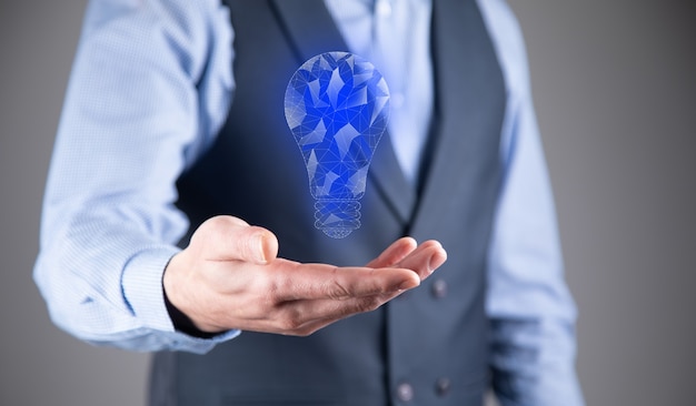 Hand holding light bulb. Smart idea icon isolated.