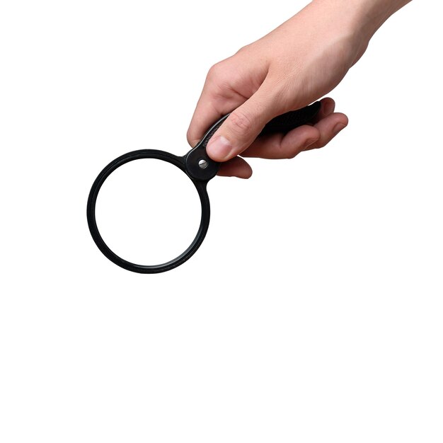 Hand holding a magnifying glass isolated. Close up.