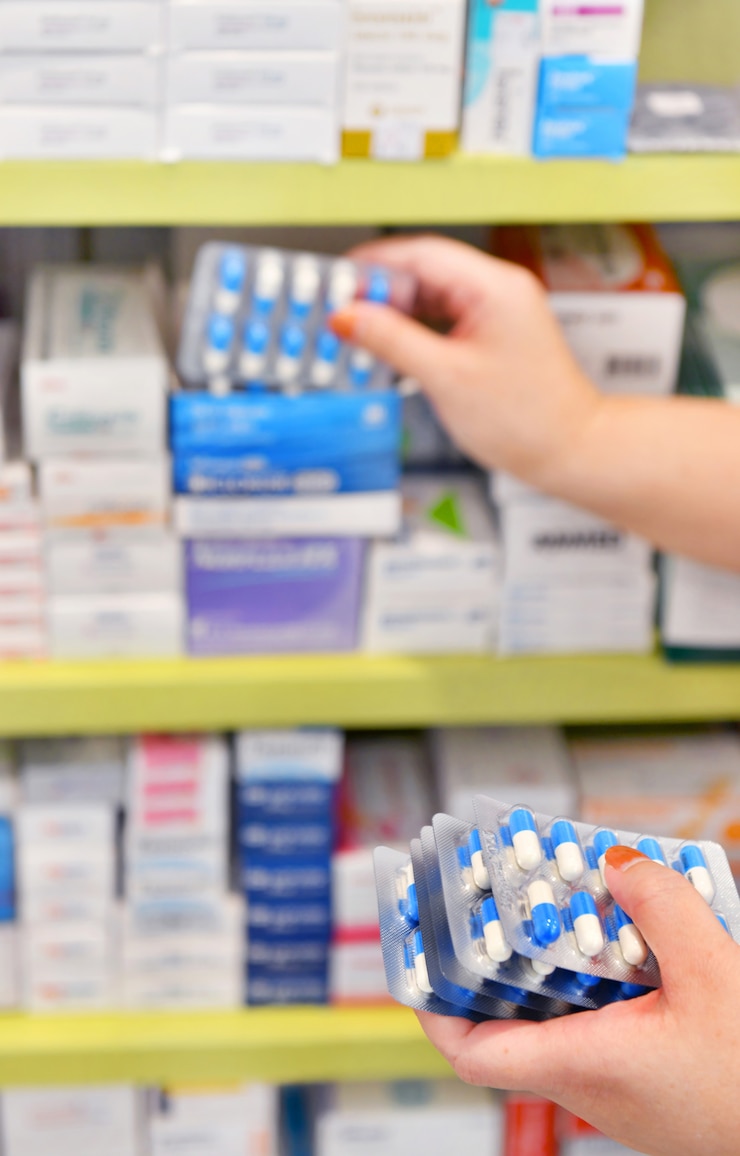 Photo hand holding medicine capsule pack at the pharmacy drugstore. 