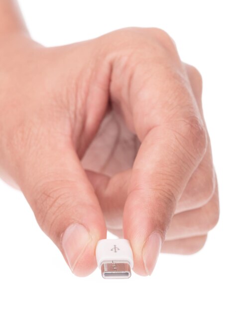 Hand holding Micro USB to USB-C adapter isolated on white background