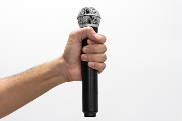 Hand holding microphone on white background