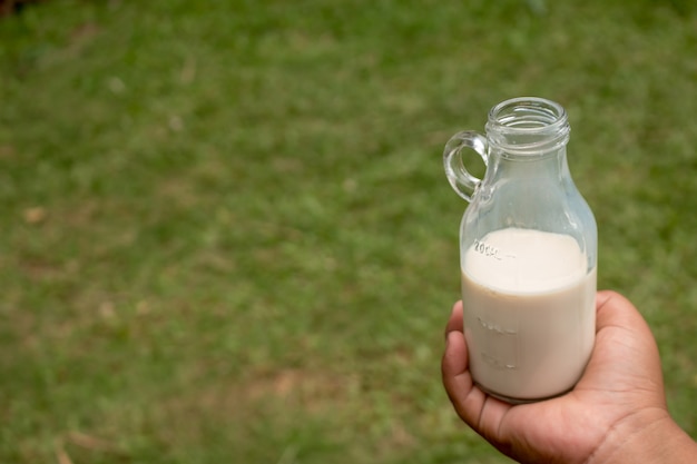 hand holding milk bottle.