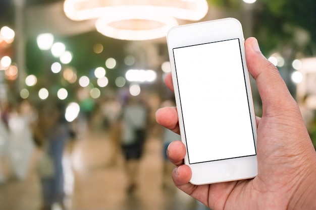 Hand holding mobile smart phone with blank screen in vertical position