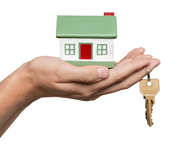 Hand Holding a Model House and Keys