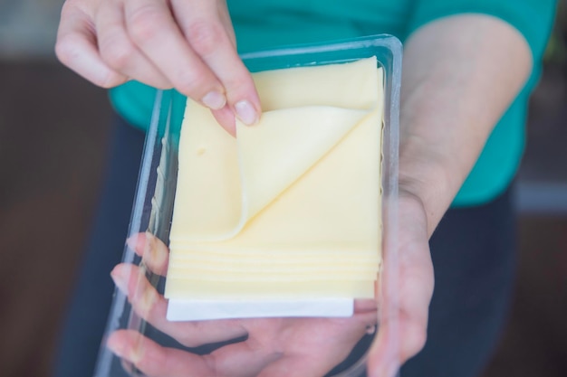 Hand holding mozzarella cheese closeup the process of preparing sandwiches a quick snack in the form