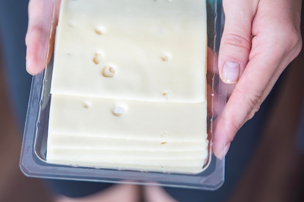 Hand holding mozzarella cheese closeup the process of preparing sandwiches a quick snack in the form