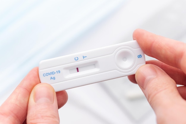 Hand holding a negative result for COVID19