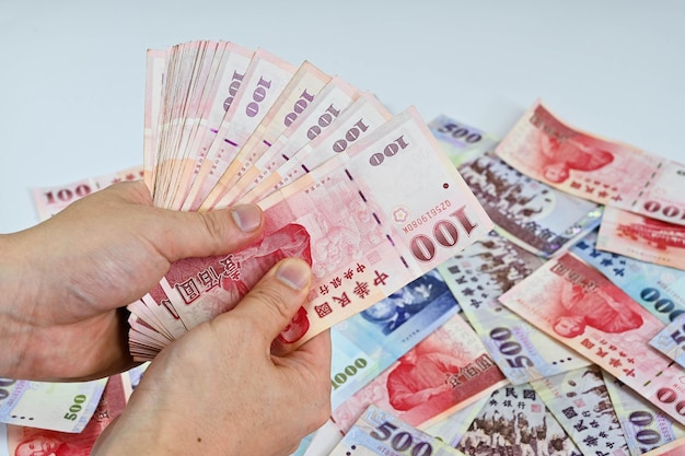 Hand holding new taiwan dollar