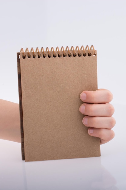 Hand holding a notebook