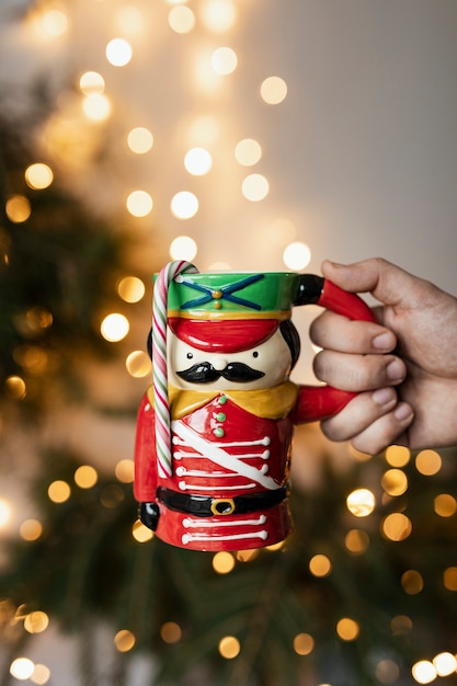 Hand holding a nutcracker mug