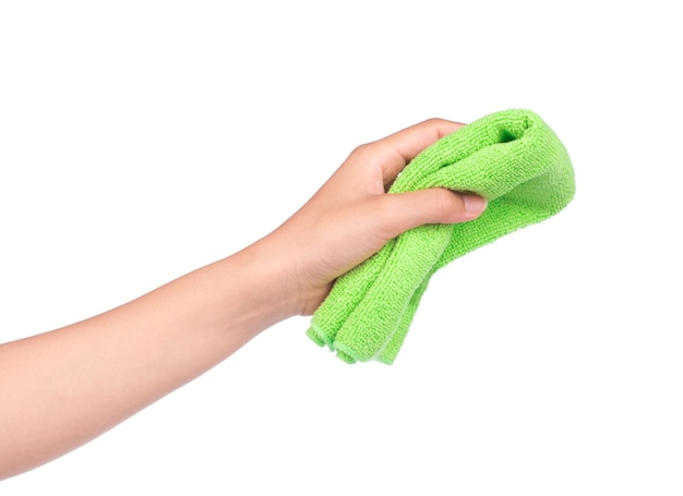 hand holding orange and green towel rolls isolated on white background.