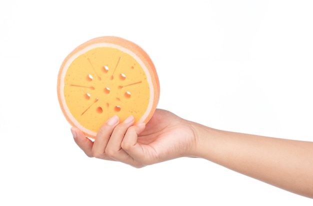 hand holding Orange sponge isolated on white background.