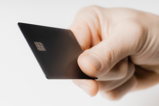 hand holding out a credit card on a white background