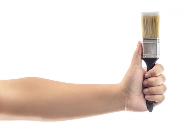 Photo hand holding paint brush with plastic black handle isolated