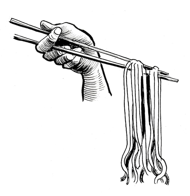 A hand holding a pair of chopsticks with chopsticks on it.