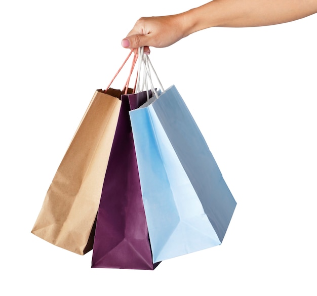 Hand holding paper shopping bags isolated on white background