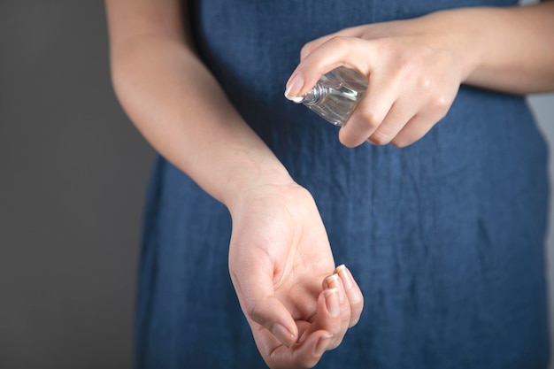 Hand holding perfume bottle