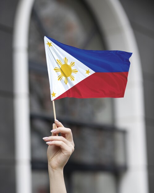 Hand holding  philippine flag