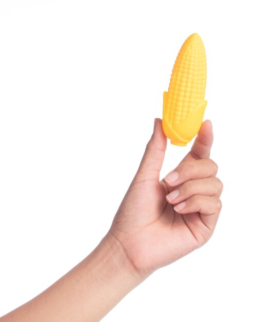 hand holding plastic toy corn isolated on white background