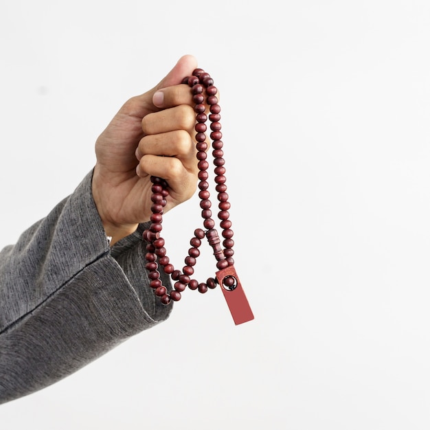 Hand holding praying muslim beads