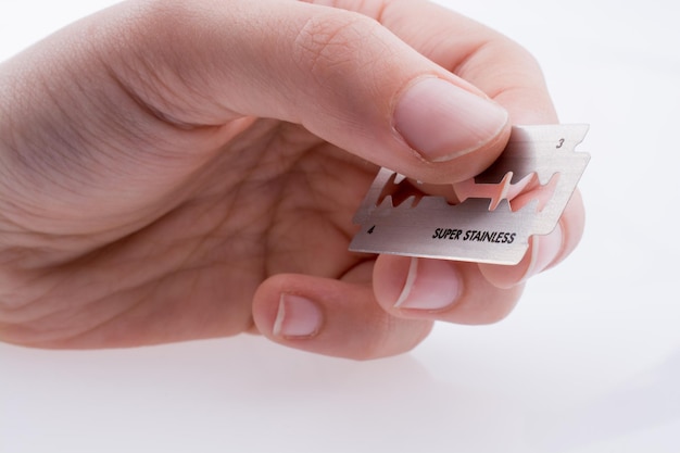 Hand holding a razor blade