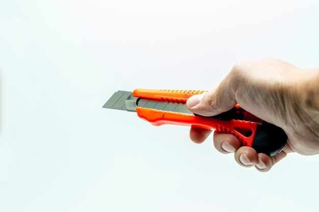 hand holding Red cutter knife