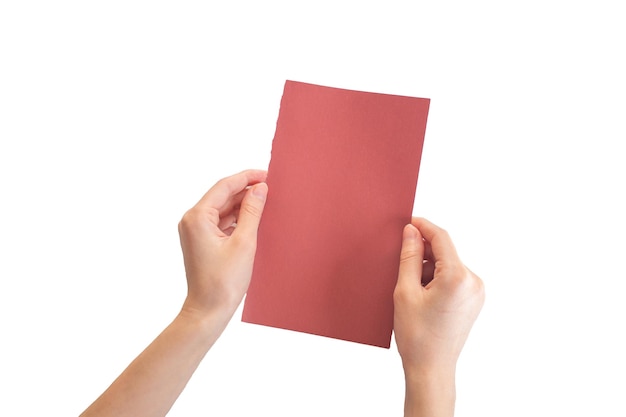 A hand holding a red paper in their hands.