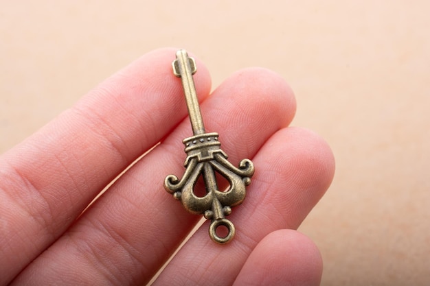 Hand holding a retro styled decorative key