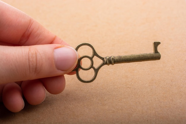 Hand holding a retro styled decorative key