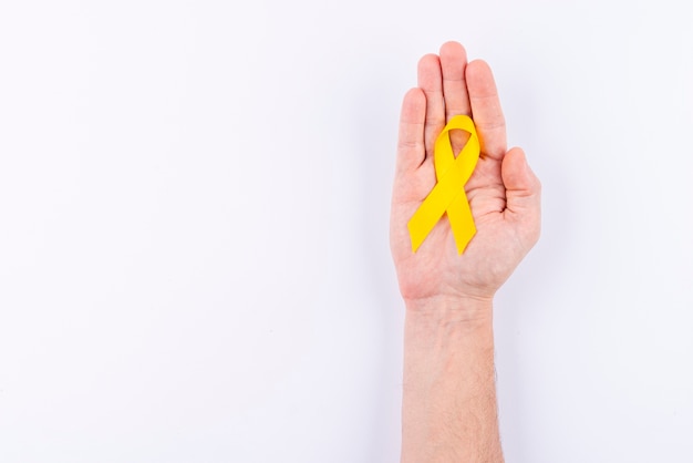 Hand holding ribbon as symbol for awareness