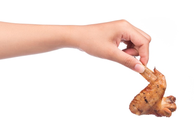 Photo hand holding roasted chicken wing isolated on white background