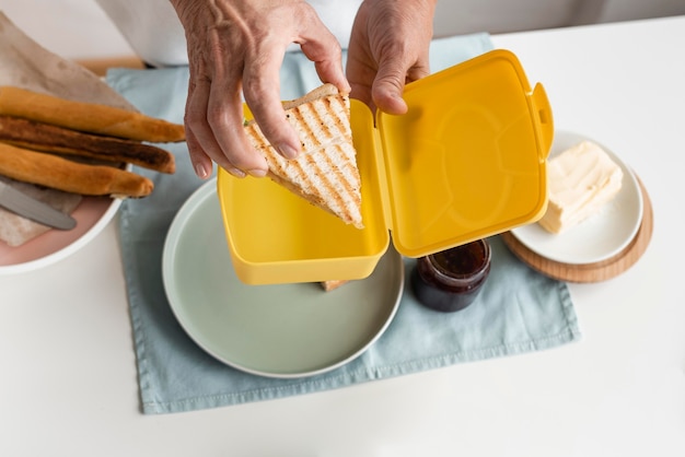 Hand holding sandwich close up