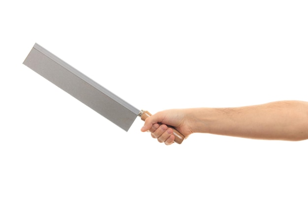 Hand holding a saw on white background