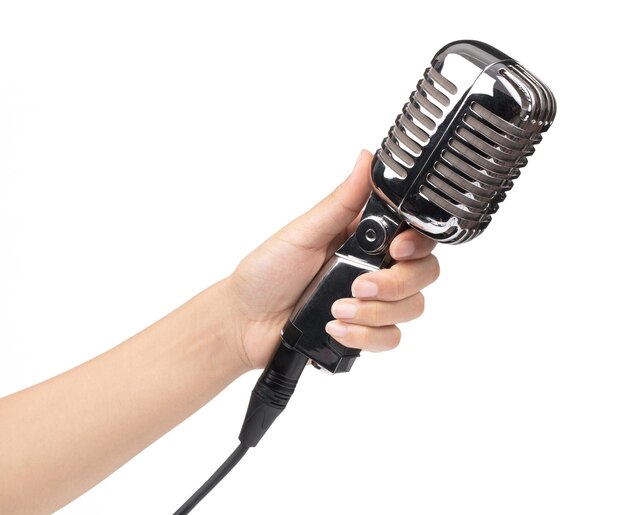 Photo hand holding a single retro microphone isolated on white background