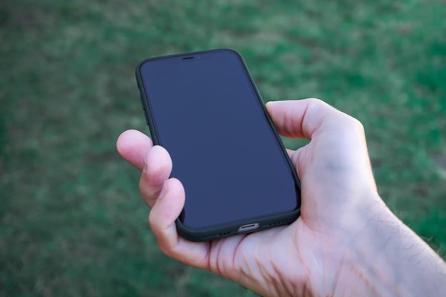 hand holding a smartphone, mobile addiction