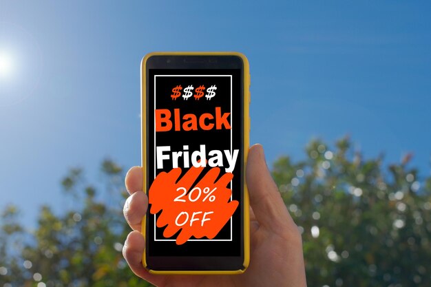 hand holding a smartphone that on the screen advertises 20 discount for black friday