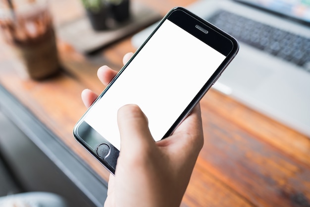 Hand holding smartphone white screen.