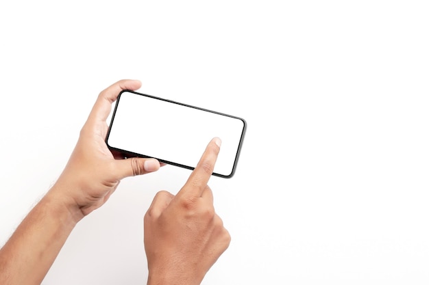 Hand holding a smartphone on a white surface.