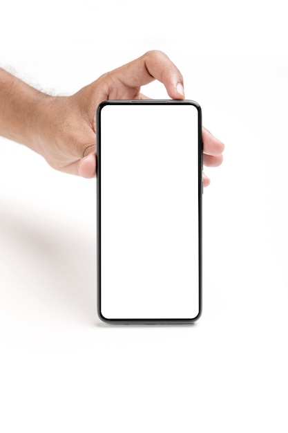 Hand holding a smartphone on a white surface.