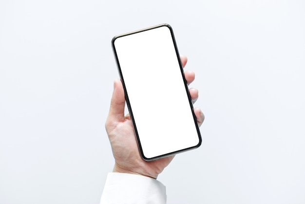 Hand holding smartphone with white screen