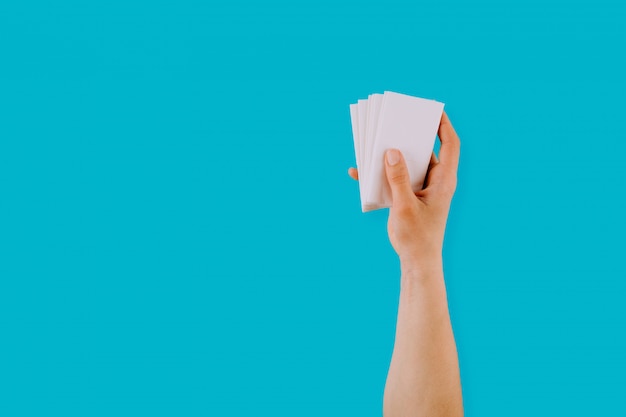 Hand holding a stack of paper sheets