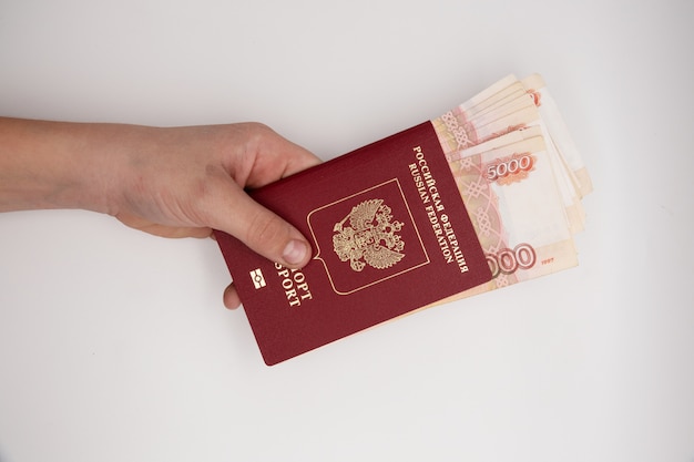 Hand holding stack of russian pasport roubles. 