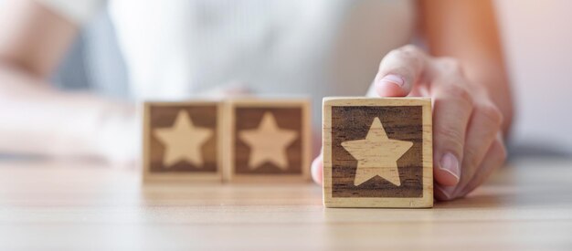 hand holding star block customer choose rating for user reviews quality service rating ranking customer review satisfaction evaluation and feedback concept